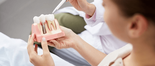 a patient learning how dental implants work in Jacksonville