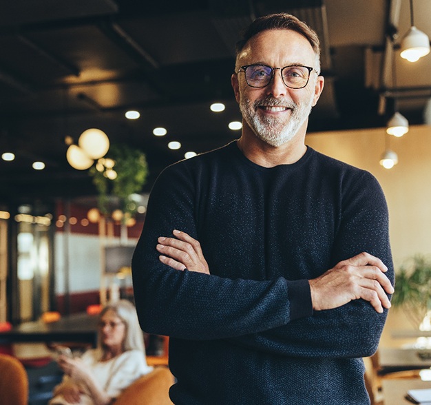 Man in black shirt smiling in work office