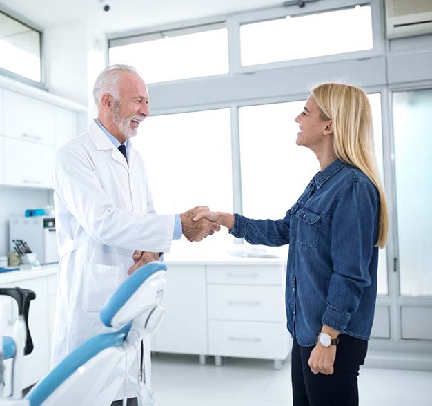 Patient shaking hands with an emergency dentist in Jacksonville
