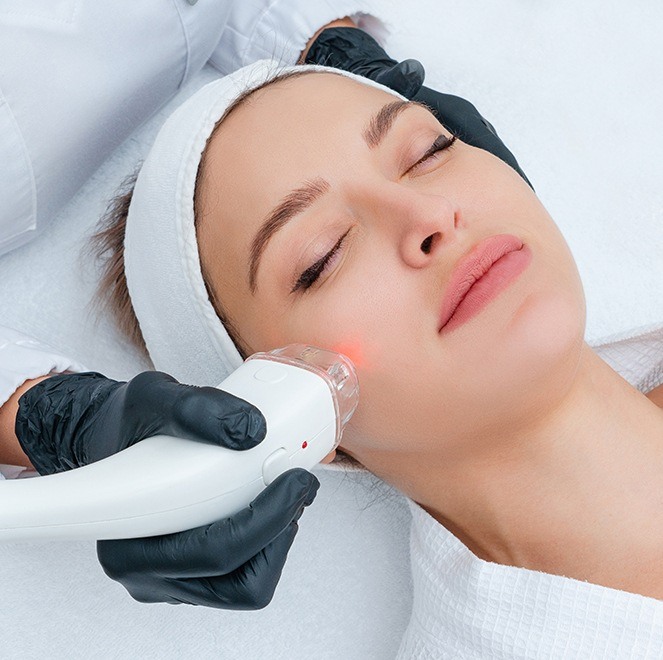 Woman receiving laser facial esthetic treatment