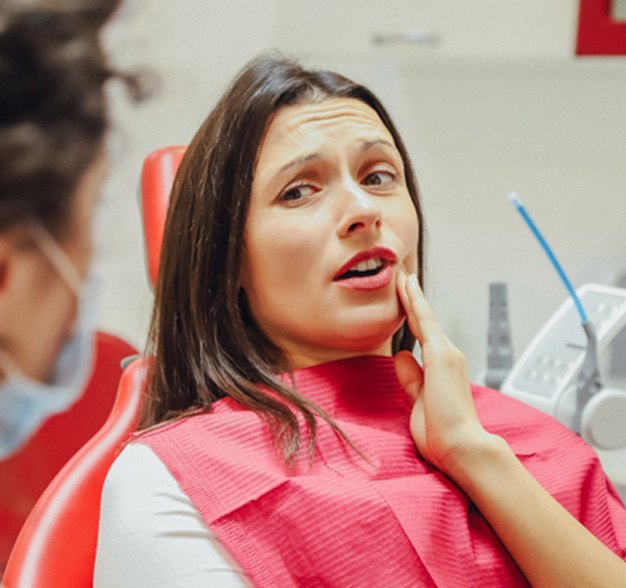 Woman with a toothache at the dentist