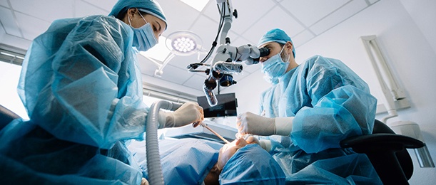 A team of dentists finishing a dental implant surgery