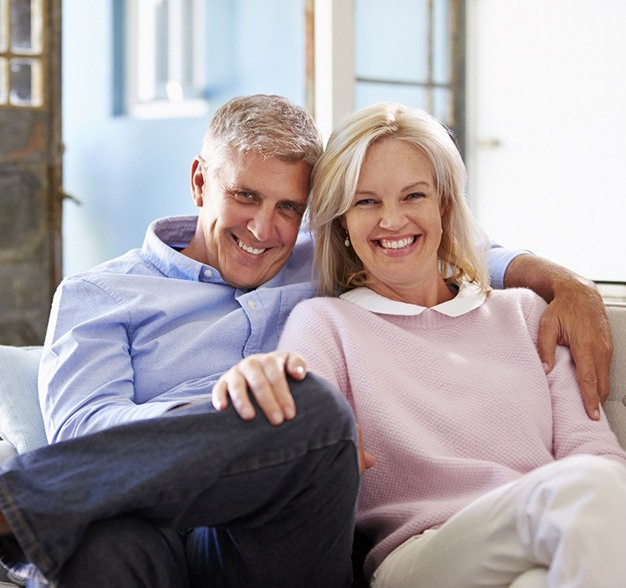 An older couple with dental implants in Jacksonville smiling