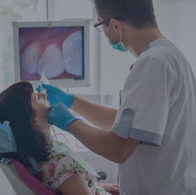 Dentist and patient looking at intraoral images