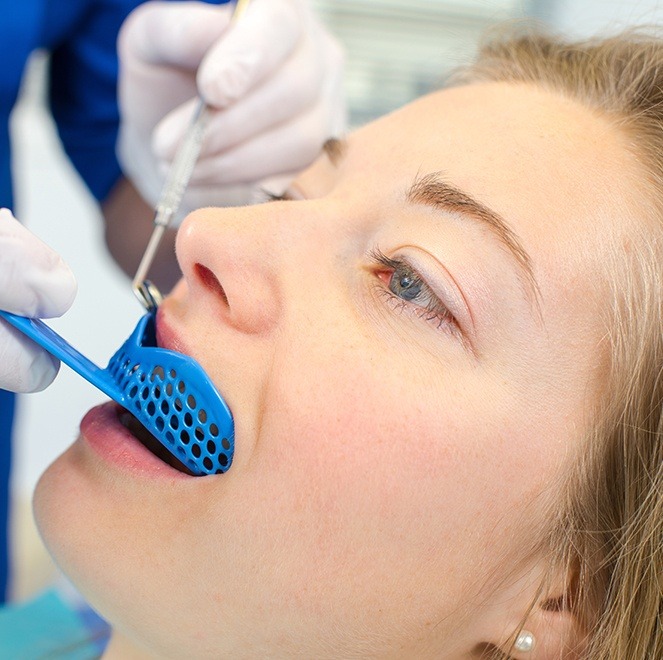 Young woman receiving fluoride treatment