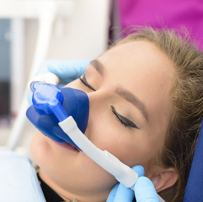 Young woman with nitrous oxide dental sedation mask