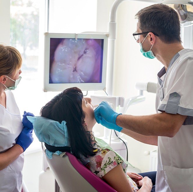 Dentist and dental patient looking at intraoral images