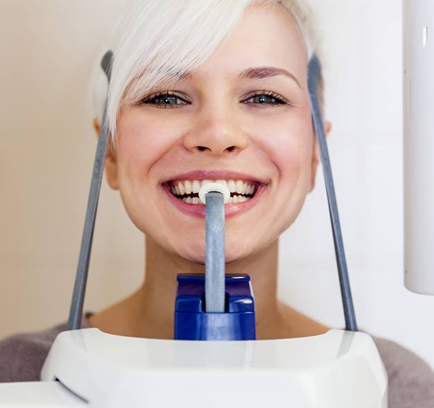 Woman receiving 3 D C T cone beam digital x-ray scan