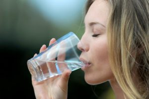 woman enjoying fluoride in drinking water