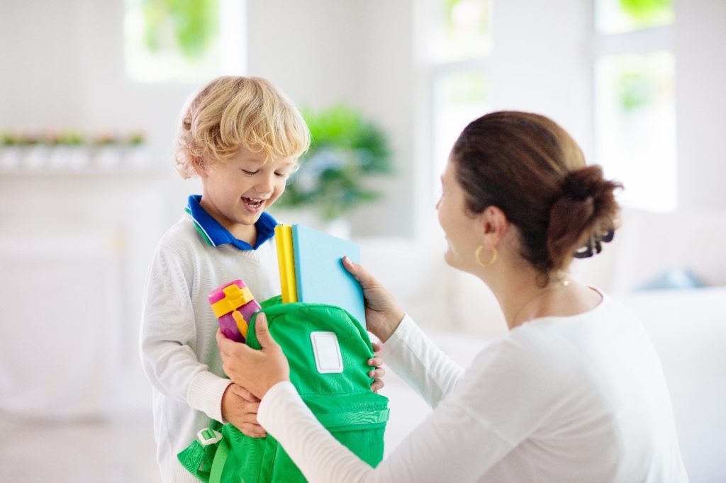 Mom helping child prepare for school