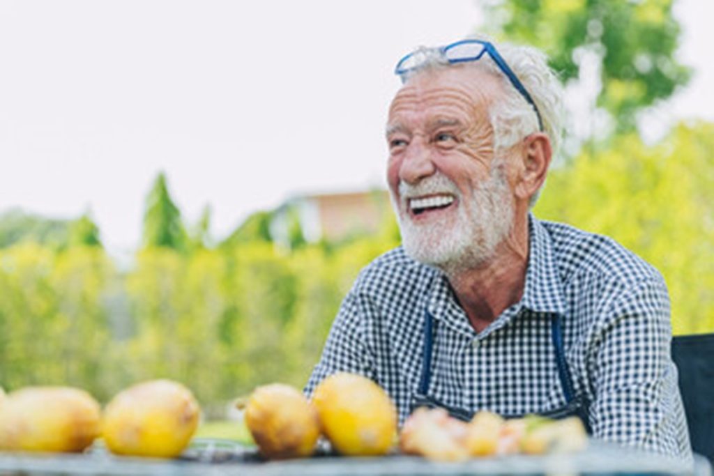 Man with dentures enjoying food.