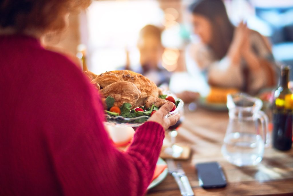Woman bringing out Thanksgiving turkey