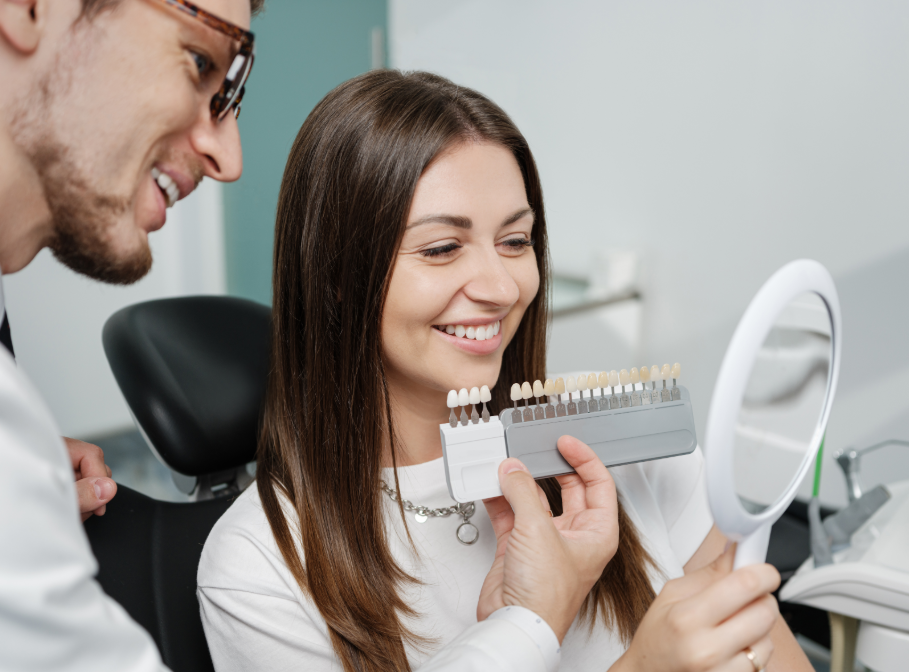 Dentist showing patient veneer options
